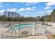 Backyard pool area featuring white fence, lounge chairs, and landscaping at 1030 Hurley School Rd, Salisbury, NC 28147