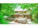 Charming home exterior with a wooden deck, screened porch, and lush greenery at 1080 Rolling Green Dr, Newton, NC 28658