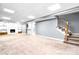 Finished basement with a fireplace, built-in shelves, and a stairway at 1080 Rolling Green Dr, Newton, NC 28658