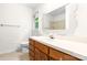 Bathroom featuring a vanity with wooden cabinets and a window with green scenery at 1080 Rolling Green Dr, Newton, NC 28658