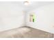 Neutral bedroom featuring carpet, a window, and simple white trim at 1080 Rolling Green Dr, Newton, NC 28658
