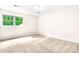 Bright bedroom with a large window showing a lush green yard and beige carpet at 1080 Rolling Green Dr, Newton, NC 28658