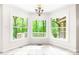 Inviting breakfast nook with large windows providing scenic views of the lush outdoors, creating a serene dining space at 1080 Rolling Green Dr, Newton, NC 28658