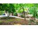 Home exterior with a screened porch, deck, lush landscaping, and charming curb appeal at 1080 Rolling Green Dr, Newton, NC 28658