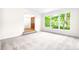 Living room featuring plush carpeting and a large window with verdant outdoor view at 1080 Rolling Green Dr, Newton, NC 28658