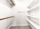 Bright walk-in closet with white shelving and wooden rods at 1080 Rolling Green Dr, Newton, NC 28658