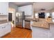 Bright kitchen featuring stainless steel appliances, granite countertops, and white cabinets, with wood floors at 10845 Hellebore Rd, Charlotte, NC 28213