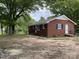 Traditional brick home featuring black shutters, a level lot, and landscaped yard at 1105 Carnation Ln, Sharon, SC 29742