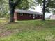 Quaint brick home with well-maintained lawn and mature trees offers classic curb appeal at 1105 Carnation Ln, Sharon, SC 29742