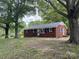 Charming brick home with black shutters, surrounded by mature trees in a peaceful setting at 1105 Carnation Ln, Sharon, SC 29742
