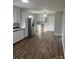 Bright kitchen featuring stainless steel refrigerator, white cabinets, and wood-look flooring at 1105 Carnation Ln, Sharon, SC 29742
