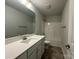 Bright bathroom featuring white cabinets, tile floors, and a large mirror at 111 High Rock Ct # 10, Statesville, NC 28677