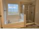 Bathroom with shower and soaking tub under a window at 111 High Rock Ct # 10, Statesville, NC 28677