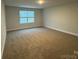 Large bedroom with carpet, neutral colors, and a window with blinds at 111 High Rock Ct # 10, Statesville, NC 28677