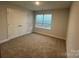 Bedroom with carpeting, closet with double doors, and a window with blinds at 111 High Rock Ct # 10, Statesville, NC 28677