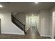 Bright foyer featuring hardwood floors, staircase, and entry door creating a welcoming atmosphere at 111 High Rock Ct # 10, Statesville, NC 28677