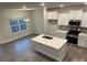 Bright kitchen featuring white cabinetry, stainless steel appliances, and an island with countertop seating at 111 High Rock Ct # 10, Statesville, NC 28677