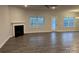 Spacious living room with a fireplace, windows, and a door leading to outdoor space at 111 High Rock Ct # 10, Statesville, NC 28677