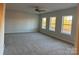 Large bedroom featuring plush carpeting, three windows, and ample natural light at 121 High Rock Ct # 08, Statesville, NC 28677