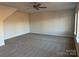 Spacious bonus room features plush carpet, ceiling fan, and abundant natural light from the window at 121 High Rock Ct # 08, Statesville, NC 28677