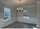 Bright dining room with wainscoting, large windows, and modern light fixture at 121 High Rock Ct # 08, Statesville, NC 28677