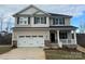 Charming two-story home featuring a two-car garage, stone accents, and a welcoming front porch at 121 High Rock Ct # 08, Statesville, NC 28677