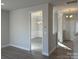 Open-concept hallway leading to a dining room with wainscoting and modern light fixture at 121 High Rock Ct # 08, Statesville, NC 28677