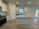Modern kitchen with stainless steel appliances, an island and granite countertops at 121 High Rock Ct # 08, Statesville, NC 28677