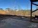 A partially cleared lot displays the patio area, tilled red clay, and a few neighboring homes in the distance at 121 High Rock Ct # 08, Statesville, NC 28677