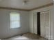 Clean bedroom with light walls, closet with louvered doors and window for natural light at 1327 Crestview Dr, Shelby, NC 28150