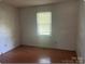 Clean bedroom with hardwood floors, a window with a blind and neutral walls at 1327 Crestview Dr, Shelby, NC 28150