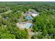 Aerial view showing the pool and tennis courts in a lush, green community at 13358 Bally Bunnion Way, Davidson, NC 28036