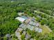 An aerial view showcases the extensive tennis facilities, pools, and a lush community at 13358 Bally Bunnion Way, Davidson, NC 28036