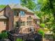 Beautiful brick home featuring an outdoor deck, manicured lawn, and meticulous landscaping at 13358 Bally Bunnion Way, Davidson, NC 28036