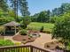 Gorgeous backyard featuring lush landscaping, a gazebo, a waterfall, and a pond at 13358 Bally Bunnion Way, Davidson, NC 28036