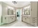 Dual vanities with marble countertops, each featuring its own mirror and lighting fixtures at 13358 Bally Bunnion Way, Davidson, NC 28036