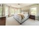 Inviting bedroom with large windows, a comfortable bed, and soft, natural light at 13358 Bally Bunnion Way, Davidson, NC 28036