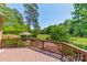 Enjoy the green view from this deck with dark railing and wooded landscaping at 13358 Bally Bunnion Way, Davidson, NC 28036