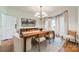 Bright dining room with natural light, a wooden table, and elegant decor at 13358 Bally Bunnion Way, Davidson, NC 28036