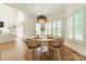 Bright dining area with hardwood floors, modern lighting, and views to the living room at 13358 Bally Bunnion Way, Davidson, NC 28036