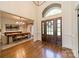 Grand foyer with hardwood floors, a view of the dining room, and natural light at 13358 Bally Bunnion Way, Davidson, NC 28036