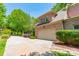 Brick home featuring an attached two-car garage and concrete driveway framed by lovely foliage at 13358 Bally Bunnion Way, Davidson, NC 28036