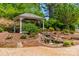 Stunning backyard featuring a gazebo with beautiful landscaping and a serene waterfall at 13358 Bally Bunnion Way, Davidson, NC 28036