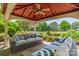 Relax in this charming gazebo featuring comfortable seating and a great view at 13358 Bally Bunnion Way, Davidson, NC 28036