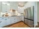 Bright kitchen featuring stainless steel appliances, white cabinets, and modern countertops at 13358 Bally Bunnion Way, Davidson, NC 28036