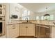 Modern kitchen with stainless steel dishwasher, marble counter tops, and an open layout to the living room at 13358 Bally Bunnion Way, Davidson, NC 28036