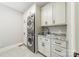 Well-organized laundry room featuring a stacked washer/dryer unit and granite counters at 13358 Bally Bunnion Way, Davidson, NC 28036