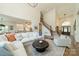 Open-concept living room featuring a soaring ceiling, hardwood floors, and stylish decor at 13358 Bally Bunnion Way, Davidson, NC 28036