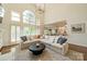 Spacious living room with high ceilings, large windows, and an open layout to the kitchen at 13358 Bally Bunnion Way, Davidson, NC 28036