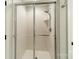 Shower room features a glass door and white tiled walls, complete with modern fixtures at 13358 Bally Bunnion Way, Davidson, NC 28036